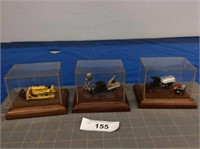 3 vintage collectibles in display cases