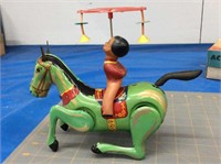 Vintage wind-up tin acrobat on horse toy