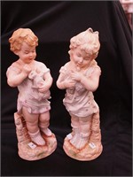 Two 13" high bisque figurines of children;