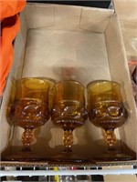 Three Amber stemmed glasses
