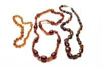 THREE AMBER BEADED NECKLACES, 178g