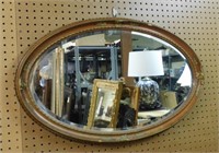 Gilt Accented Oval Beveled Wall Mirror.