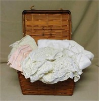 Basket of Linen and Lace Tablecloths.