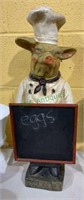 Molded pig decoration posing as a chef - stands 22