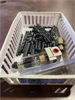 White plastic container with drill bits, plasma