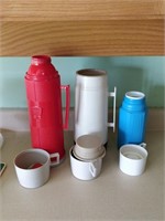 lot of containers , thermos , etc