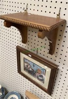 Small wall shelf with a framed print of a family