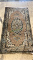 Small Persian style carpet rug with several