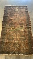 Antique woven rug with wear spots. Has a 2 inch