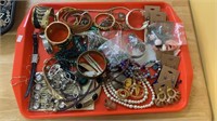 Tray of costume jewelry including big bangles,