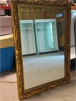 Large gold ornate mirror, contents in background