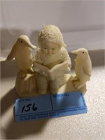 Snow baby with penguins figurine