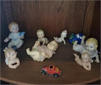 7 Doll Figurines And 2 Cars