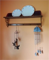 Shelf With Plates And Wind Chimes