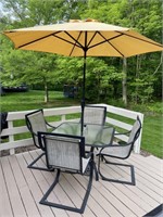 Outdoor patio set with four chairs and umbrella