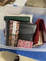 Photo albums and plastic tote