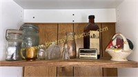 Vintage bottles and jars on top shelf