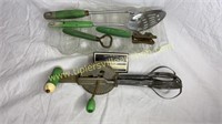 Green handle utensils and glass corn stick pan