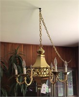 Fine hanging gold lamp over piano