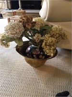 Heavy brass bowl with floral sitting in it