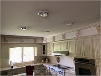 8 pottery ivory plaques above cabinets in kitchen