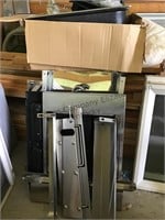 Unassembled stainless steel cabinet with sink.