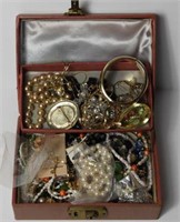 Jewelry box full of costume jewelry: necklaces,