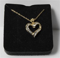 Marked 14kt gold ladies heart pendant with stones
