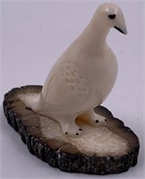 Mike Kiyuklook Ivory carving of a bird on a heavil