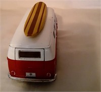 Red VW Peace & Love Bus with with surfboard