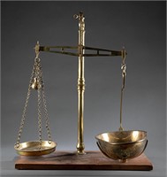 English brass balance scales on wood stand.
