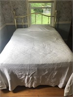 Brass full sized bed with bates I’ll coverlet.