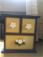 Painted wood jewelry box with flower knobs.