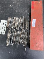 Over 50 drill bits and metal toolbox