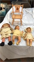 Three vintage dolls and a doll chair