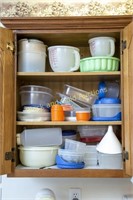 Cabinet full of assorted plastic kitchen ware