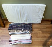 Five assorted throw rugs and a crib pad
