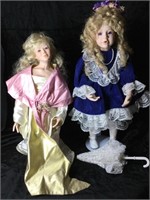 Two porcelain dolls on stands.  22” and 18”.