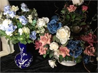 Two artificial flower arrangements in vases.
