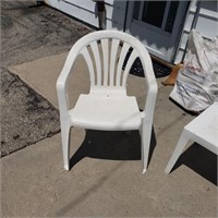 2 white plastic patio chairs and table