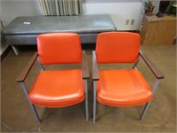 (2)Orange office chairs.