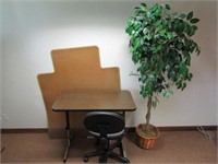 Desk, chair, floor mat, artificial tree.