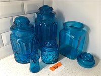 A Collection of Blue Glass Jars and Covers