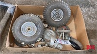 Box with miscellaneous mower tires and wheels