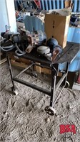 Small work table on steel wheels and castors