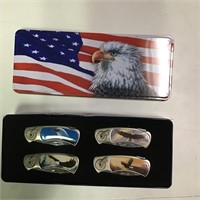 Eagle knife set in tin set of 4, (tin is dented)