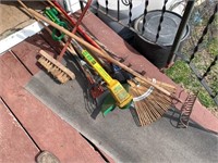 electric trimmer, rakes, brooms, old baseball bat.