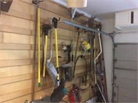 Long handled tools on wall