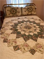Brass full size bed with machine made coverlet