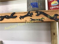 Assorted wrenches hanging on shelf